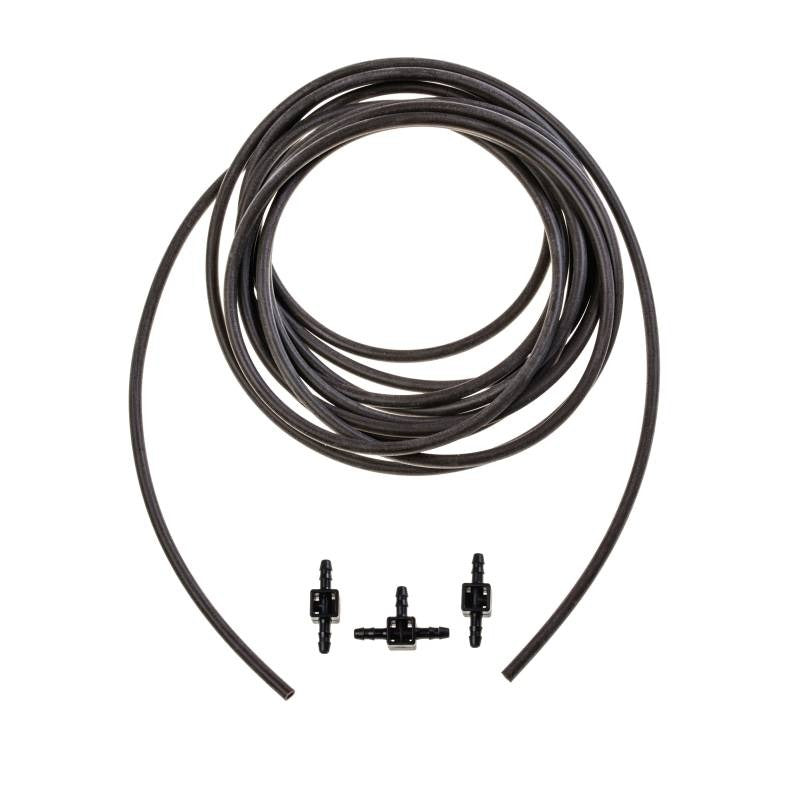Load image into Gallery viewer, Coiled Blumat drip tubing beside two couplings and a tee
