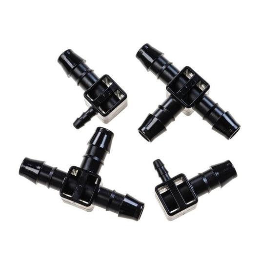Two Blumat tee fittings and two elbow end pieces arranged together