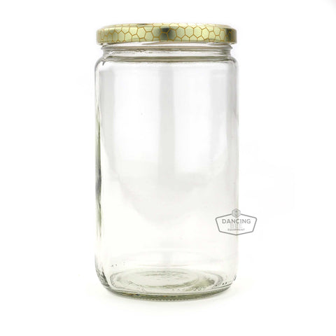 Glass cylinder honey jar with honeycomb-print lid, 1 kg capacity.