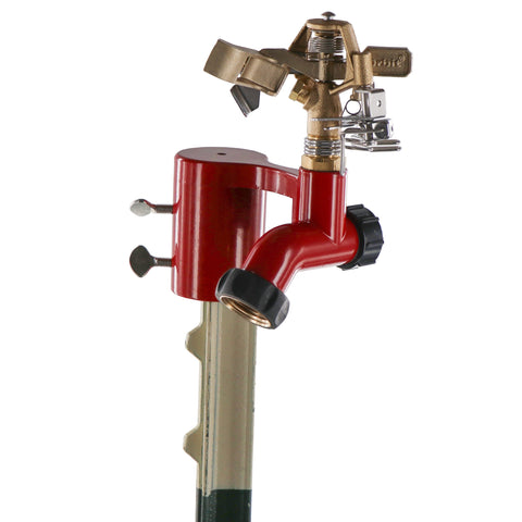 Orbit brass impact sprinkler on fence T-post base