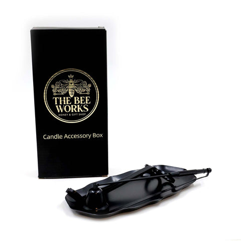 Four-piece candle accessory kit with tray, wick trimmer, snuffer, and dipper.