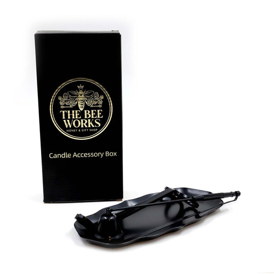 Four-piece candle accessory kit with tray, wick trimmer, snuffer, and dipper.