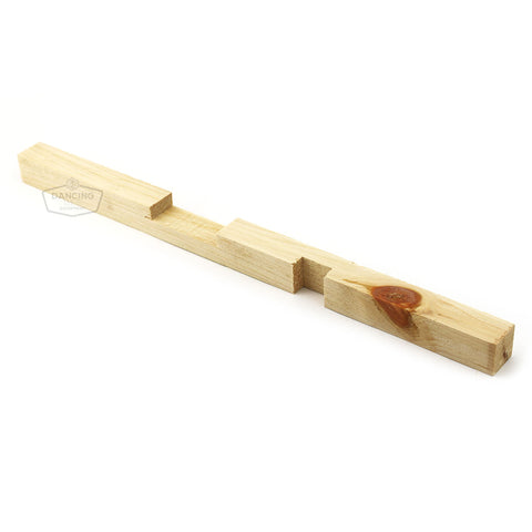 Wooden entrance reducer with two seasonal opening sizes for hive traffic control.