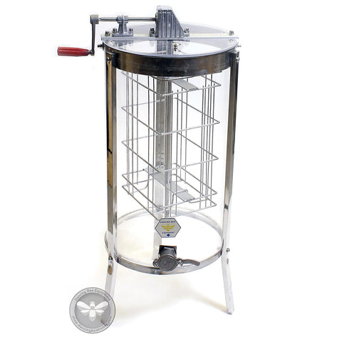 Two-frame acrylic manual honey extractor with stainless steel internal frame, clear view.