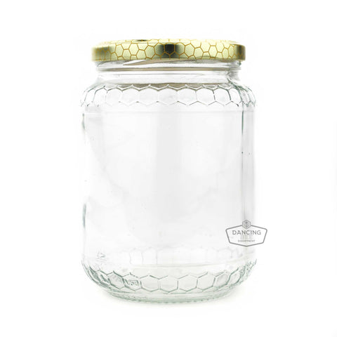 Glass honey jar with embossed honeycomb pattern and lid, 1 kg capacity.