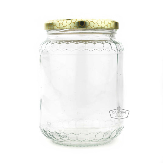 Glass honey jar with embossed honeycomb pattern and lid, 1 kg capacity.
