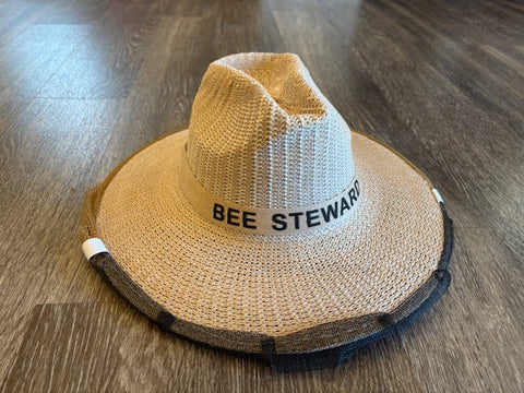 Straw hat with attached mesh beekeeping veil and underarm straps.