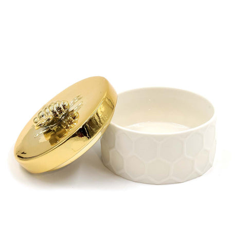 White and gold ceramic accessory box with decorative bee-shaped knob.