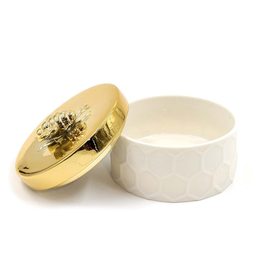 White and gold ceramic accessory box with decorative bee-shaped knob.