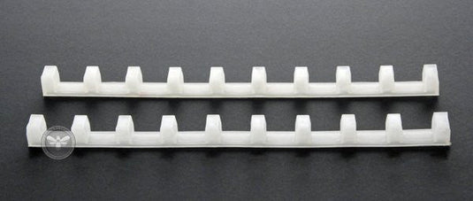 Plastic frame spacing tool positioning nine frames evenly in a super.