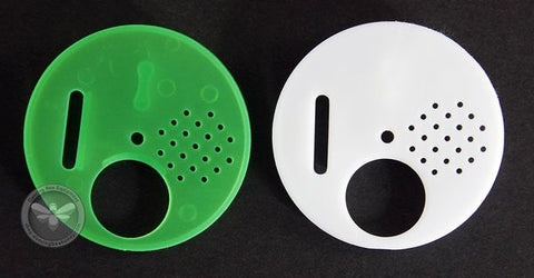Plastic entrance disc mounted on a hive for controlling bee traffic.