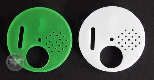 Plastic entrance disc mounted on a hive for controlling bee traffic.